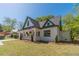 Lovely home with cream and green paint, complemented by a well-kept lawn and classic American flag at 181 W Hightower Trl, Social Circle, GA 30025