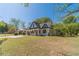 Inviting cream and green home featuring a lush lawn and covered carport, blending charm with functionality at 181 W Hightower Trl, Social Circle, GA 30025