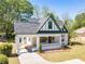 Charming two-story home with a landscaped yard, covered porch, and beautifully painted in cream and green at 181 W Hightower Trl, Social Circle, GA 30025