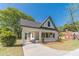 A cream and green painted home enhanced by a spacious lawn and a convenient covered carport, ready for move-in at 181 W Hightower Trl, Social Circle, GA 30025