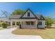 Attractive cream and green home with a covered carport, manicured lawn, and charming curb appeal at 181 W Hightower Trl, Social Circle, GA 30025