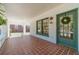 Charming front porch with brick tiles, and a decorative door, creating an inviting entrance to the home at 181 W Hightower Trl, Social Circle, GA 30025