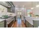 Updated kitchen with stainless steel appliances and farmhouse sink; adjoins a stylish laundry room at 181 W Hightower Trl, Social Circle, GA 30025