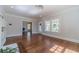 Bright living room featuring hardwood floors, large windows, and an open floor plan at 181 W Hightower Trl, Social Circle, GA 30025