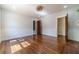Spacious living room with hardwood floors, classic trim, and multiple doorways with vintage doors at 181 W Hightower Trl, Social Circle, GA 30025