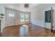 Sunlit living room featuring hardwood floors, white trim, fireplace, and a door to the bathroom at 181 W Hightower Trl, Social Circle, GA 30025
