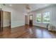 Spacious living room with hardwood floors, natural light, and access to other rooms at 181 W Hightower Trl, Social Circle, GA 30025