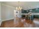 Open floor plan with hardwood floors, a modern kitchen, and seamless flow to the living area at 181 W Hightower Trl, Social Circle, GA 30025