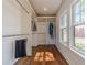 Bright walk-in closet with hardwood floors, built-in shelving, and a large window at 181 W Hightower Trl, Social Circle, GA 30025