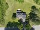 Aerial view featuring a home with a spacious yard, surrounding trees, and convenient driveway parking at 2156 Fairway Cir, Duluth, GA 30096