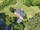 Aerial view of a home with a large backyard, mature trees, and a paved driveway leading to the residence at 2156 Fairway Cir, Duluth, GA 30096