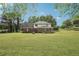 Expansive backyard with lush green grass, mature trees, and a view of the home at 2156 Fairway Cir, Duluth, GA 30096