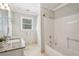 Bathroom featuring granite countertops, a tub-shower combo, ample cabinet space, and a large mirror with modern lighting at 2156 Fairway Cir, Duluth, GA 30096