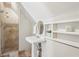 Modern bathroom with a pedestal sink and tiled shower stall, offering a clean and minimalist design at 2156 Fairway Cir, Duluth, GA 30096