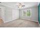 Bedroom featuring carpet floors, closet, ceiling fan, and a window for natural light at 2156 Fairway Cir, Duluth, GA 30096