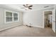 Bedroom featuring carpet floors, ceiling fan and a window offering natural light at 2156 Fairway Cir, Duluth, GA 30096