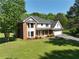 Beautiful two-story home with a well-manicured lawn, brick accents, and a charming front entrance at 2156 Fairway Cir, Duluth, GA 30096