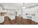 Kitchen with white cabinets, granite countertops and dark wood floors at 2156 Fairway Cir, Duluth, GA 30096