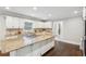Kitchen with white cabinets, granite countertops and dark wood floors at 2156 Fairway Cir, Duluth, GA 30096