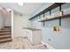 Bright laundry room features blue walls, modern shelving, and a convenient sink for easy washing and cleaning at 2156 Fairway Cir, Duluth, GA 30096