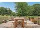 Outdoor dining area on a wooden deck with a table, seating for six, and a view of the lush backyard at 2156 Fairway Cir, Duluth, GA 30096