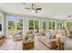 Sunroom featuring large windows, tile floors, comfortable seating, and views of the backyard at 2156 Fairway Cir, Duluth, GA 30096