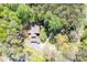 A beautiful aerial view of a house nestled in a dense, green forest canopy at 3141 Burnt Hickory Nw Rd, Marietta, GA 30064