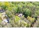An aerial view of a house surrounded by lush greenery and mature trees in a wooded neighborhood at 3141 Burnt Hickory Nw Rd, Marietta, GA 30064