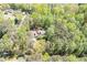 Aerial view of house nestled among mature trees in a quiet neighborhood at 3141 Burnt Hickory Nw Rd, Marietta, GA 30064