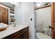 Bathroom with marble countertops, decorative wallpaper and a glass shower at 3141 Burnt Hickory Nw Rd, Marietta, GA 30064