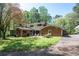 Brick home featuring a rear patio, green lawn, and mature shade trees at 3141 Burnt Hickory Nw Rd, Marietta, GA 30064