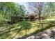 Spacious brick home set in a lush, green surrounding with mature trees at 3141 Burnt Hickory Nw Rd, Marietta, GA 30064