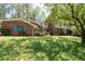 Charming brick home with vibrant blue shutters and a spacious two-story section with a covered balcony at 3141 Burnt Hickory Nw Rd, Marietta, GA 30064