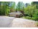 Lovely home featuring an attached garage and surrounded by lush green trees and landscaping at 3141 Burnt Hickory Nw Rd, Marietta, GA 30064