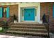 The home's front porch leads to turquoise double doors and black wrought iron railings at 3141 Burnt Hickory Nw Rd, Marietta, GA 30064