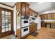 A view of the kitchen and the surrounding area with wooden cabinets, hardwood floors, and appliances at 3141 Burnt Hickory Nw Rd, Marietta, GA 30064