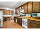 Wide kitchen view of the built-in desk, appliances and dark wooden cabinets throughout the kitchen at 3141 Burnt Hickory Nw Rd, Marietta, GA 30064
