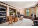 Cozy living room with built-in bookshelves, wood trim, neutral carpet, and natural light from the large windows at 3141 Burnt Hickory Nw Rd, Marietta, GA 30064