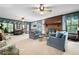Open-concept living room with cozy seating, brick fireplace, large windows, and a dining area at 3141 Burnt Hickory Nw Rd, Marietta, GA 30064