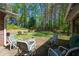 Cozy outdoor patio featuring comfortable seating overlooking a wooded lot at 3141 Burnt Hickory Nw Rd, Marietta, GA 30064