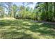 Large grassy front yard leading up to a brick home with mature trees at 3141 Burnt Hickory Nw Rd, Marietta, GA 30064