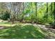 Backyard featuring a grassy area and mature shade trees at 3141 Burnt Hickory Nw Rd, Marietta, GA 30064