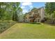 Manicured backyard with a lush lawn, deck, and well-maintained landscaping at 3870 Cabalzar St, Cumming, GA 30040