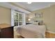 Cozy bedroom featuring a large window, comfortable bed, and stylish decor at 3870 Cabalzar St, Cumming, GA 30040