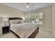 Cozy bedroom with a dark-wood bed frame and a bright window at 3870 Cabalzar St, Cumming, GA 30040