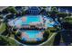 Aerial view of a large community pool with waterslides, pergolas, and lounge chairs at 3870 Cabalzar St, Cumming, GA 30040