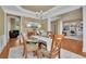 Open-concept dining room with hardwood floors and views of the living spaces at 3870 Cabalzar St, Cumming, GA 30040