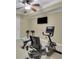 Home gym with exercise bike, weight bench, and a ceiling fan at 3870 Cabalzar St, Cumming, GA 30040