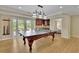 Spacious game room with a billiard table, bar area, and access to the outdoor patio at 3870 Cabalzar St, Cumming, GA 30040
