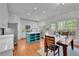Open kitchen with an island, stainless appliances, and an adjacent dining area with deck access at 3870 Cabalzar St, Cumming, GA 30040
